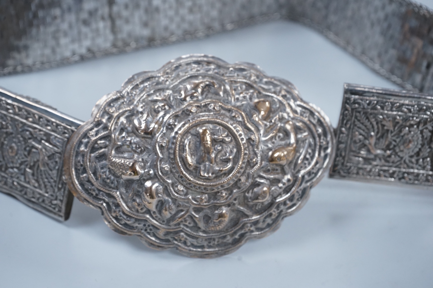 An early 20th century Chinese Straits repoussé white metal belt and buckle, stamped marks, 273g